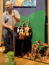 Thad Beach playing guitar, ukulele, limberjack, washboard, harmonica